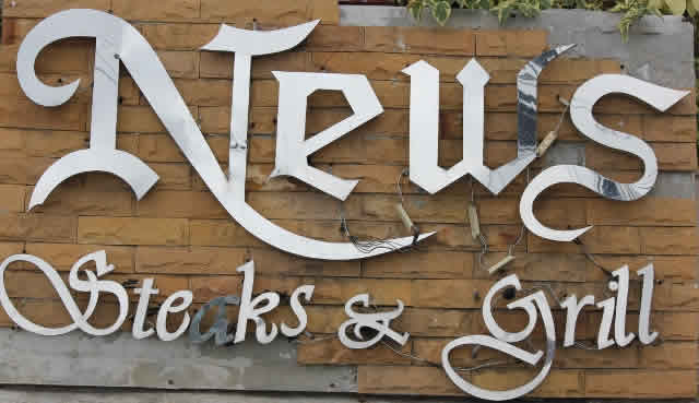 News steak and grill sign